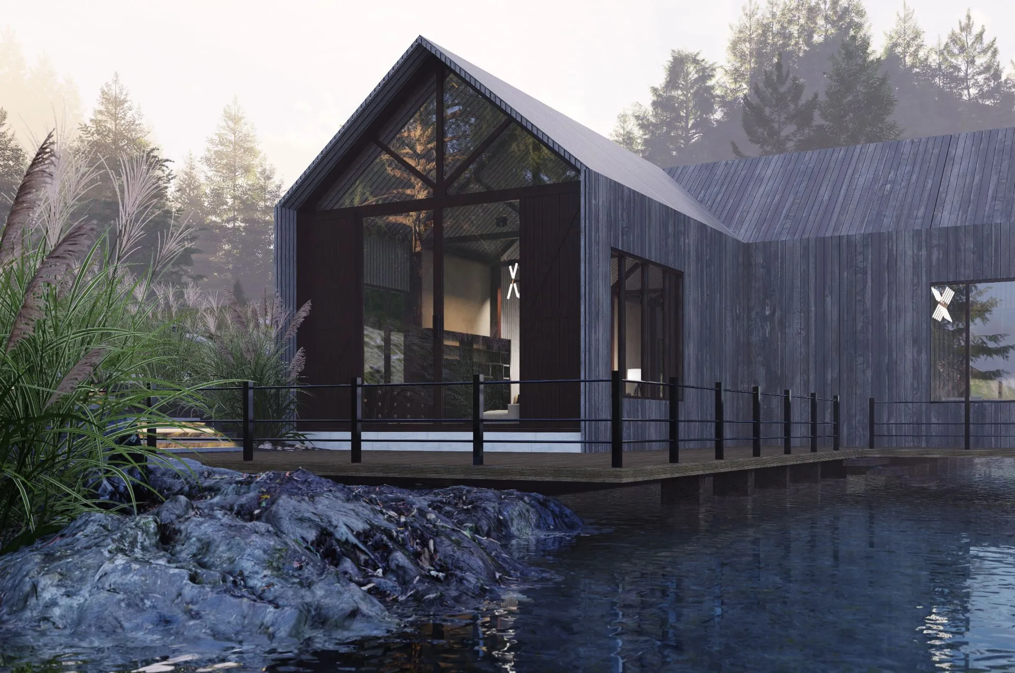 The dark timber-clad cabin with a fully glazed gable end and a railed deck over the water, rocks and tall grasses in the foreground, misty pine forest behind.